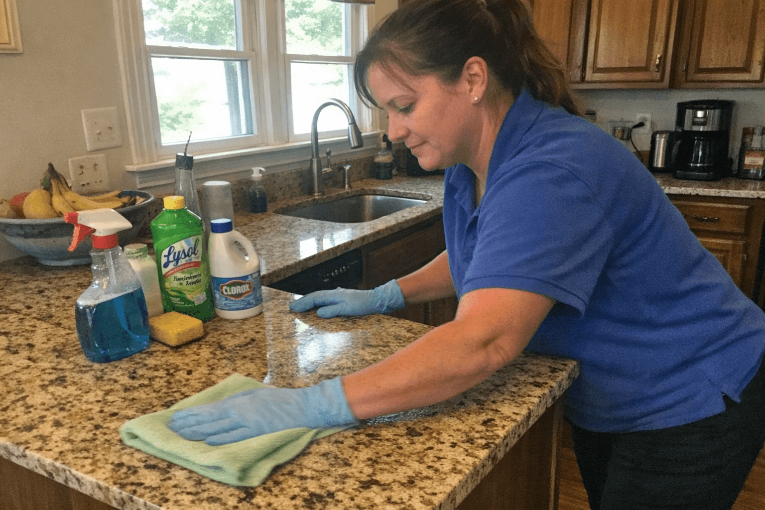 Professional cleaner cleaning a kitchen counter
